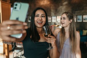 Women in a bar taking a selfie